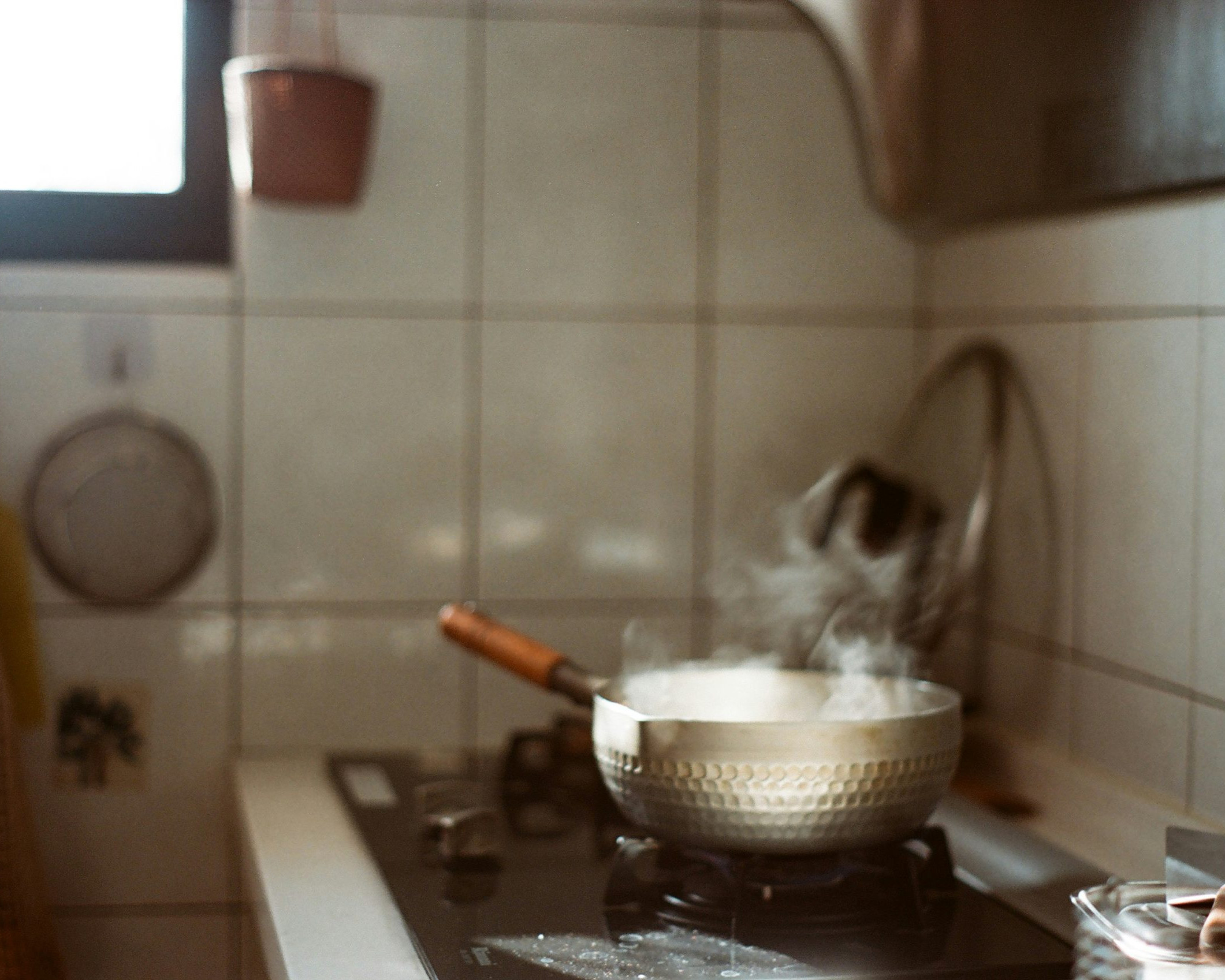 a steaming pot on a kitchen stove