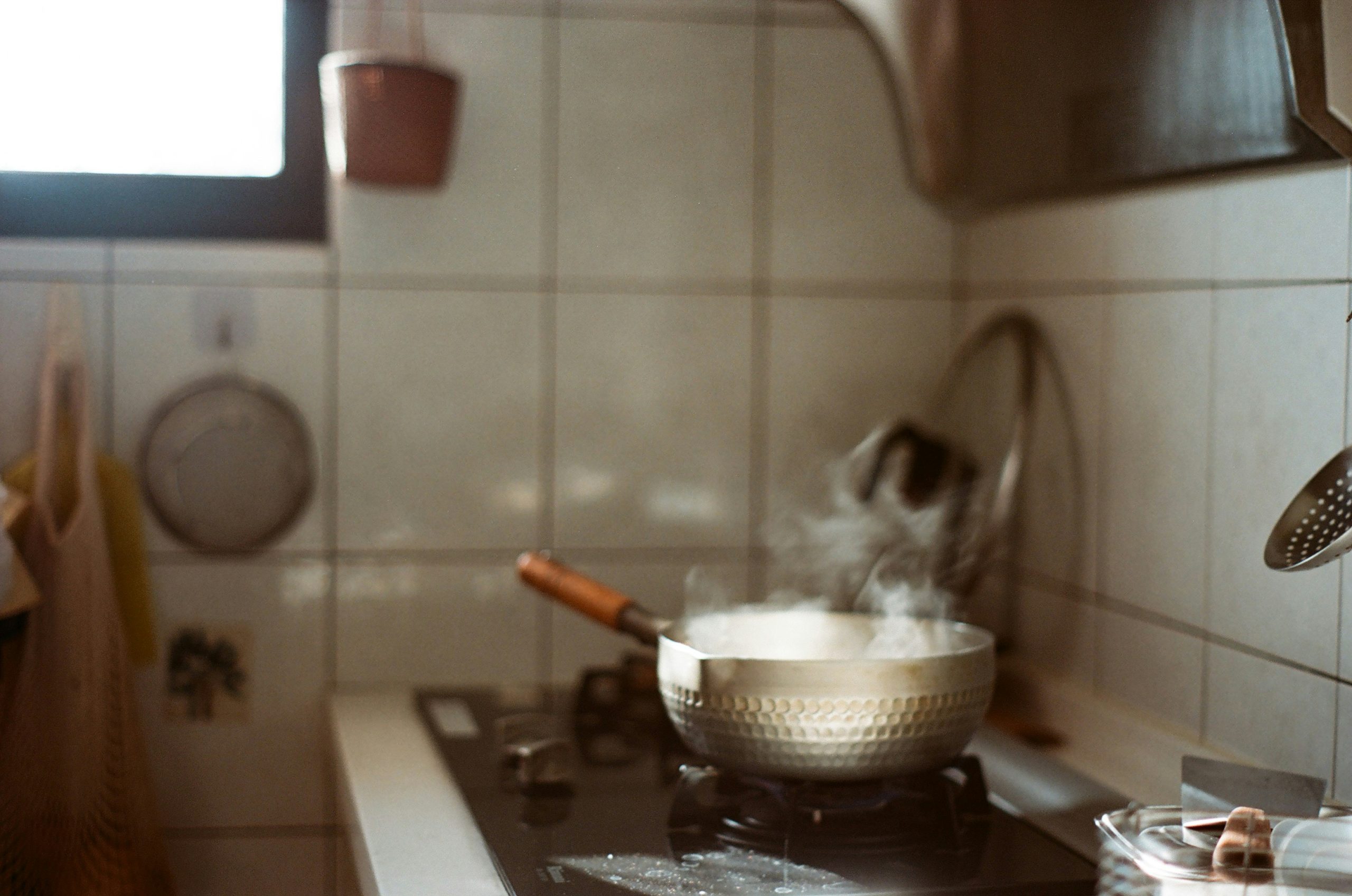 a steaming pot on a kitchen stove